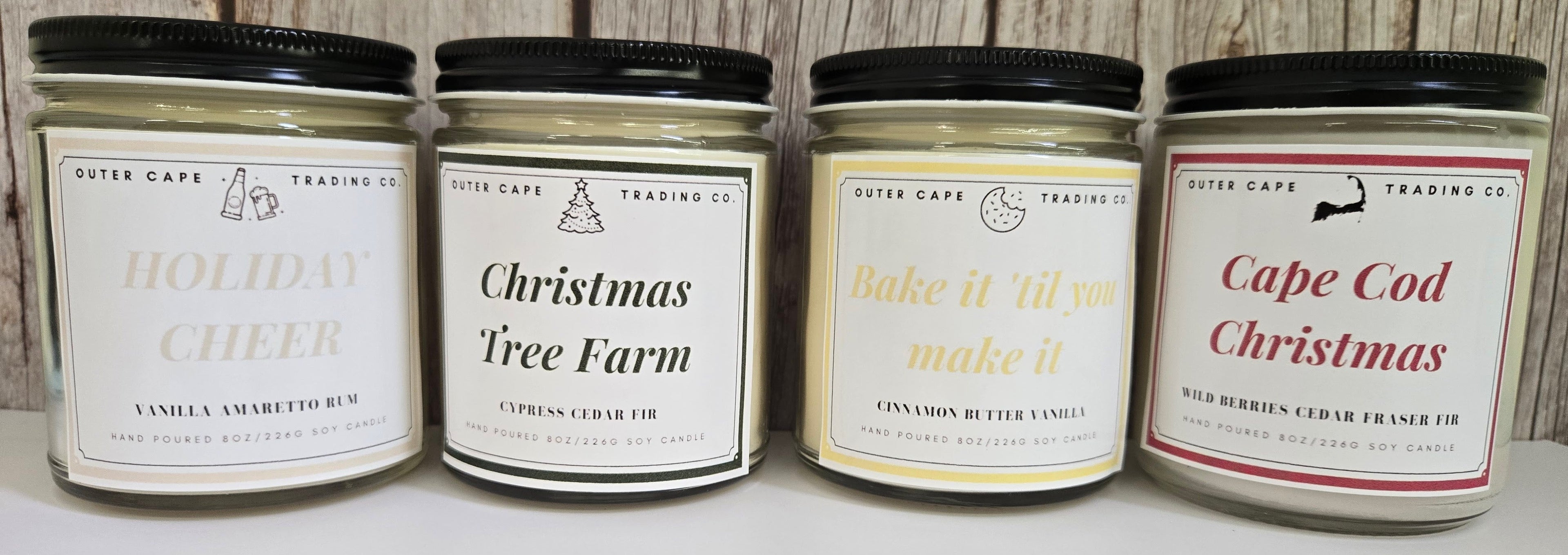 Outer Cape Trading 2025 Holiday Candle Collection. Holiday Cheer, Christmas Tree Farm, Bake it 'til you make it, and Cape Cod Christmas.